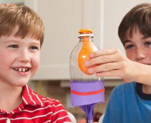 Two students building a lung out of a bottle and a balloon in a science experiment