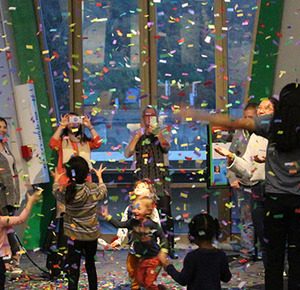A group gathers to celebrate new years with falling confetti