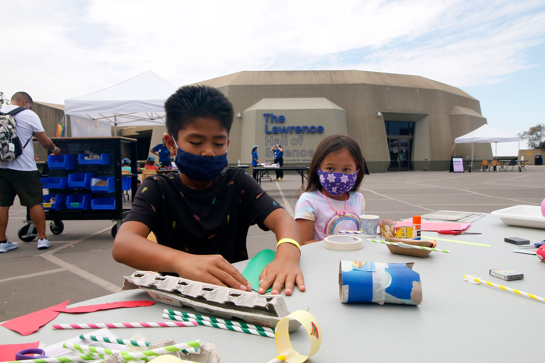 Two children constructing paper sculptures during Summer Fundays at The Lawrence