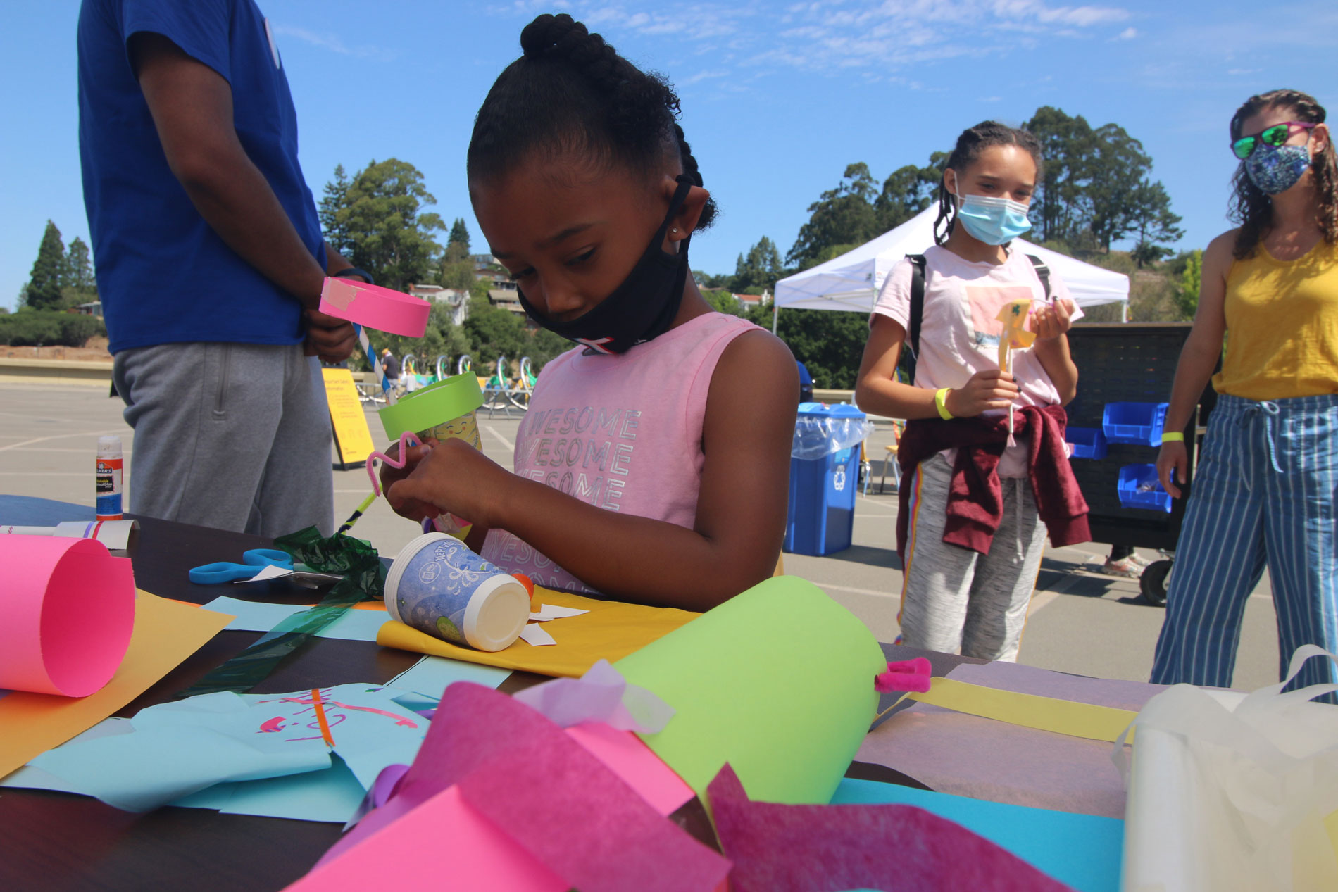 A child constructing a paper sculpture during Summer Fundays at The Lawrence