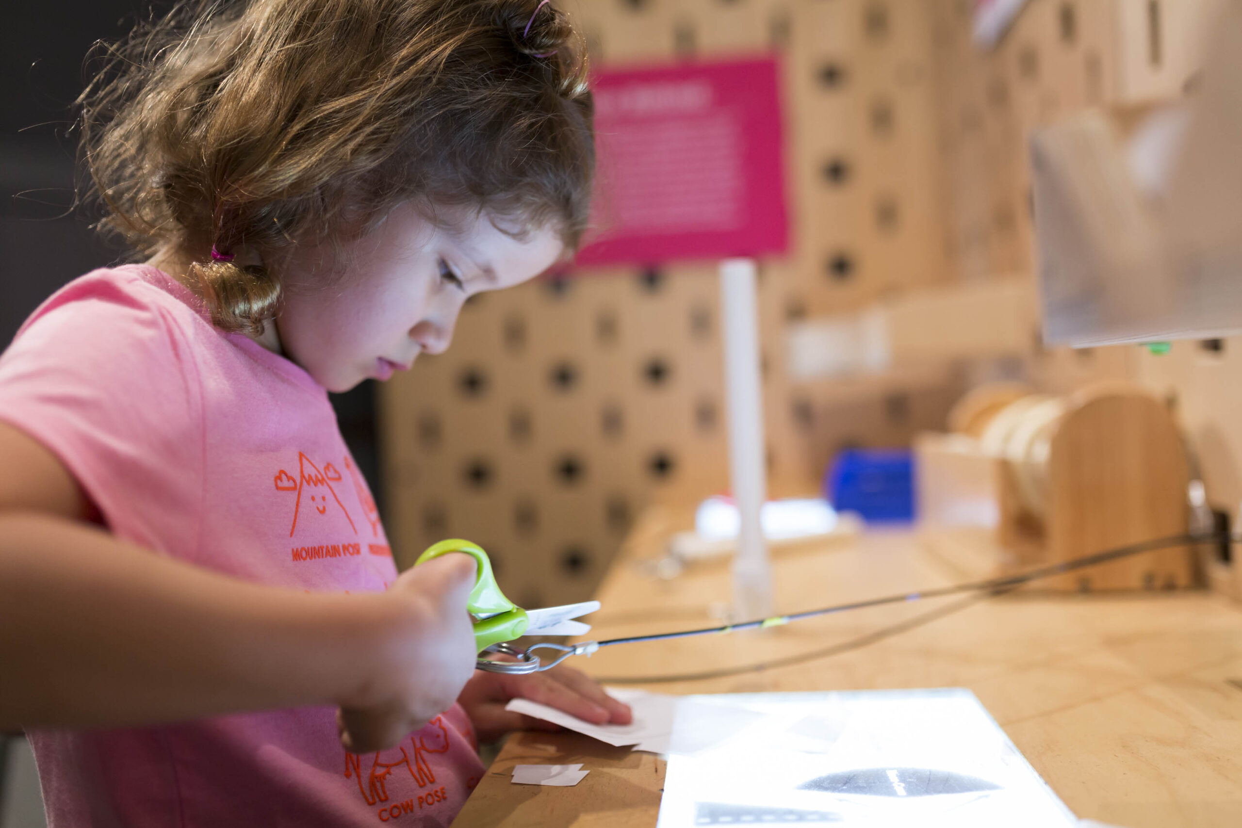 A child creating her own invention at the Make Station exhibit