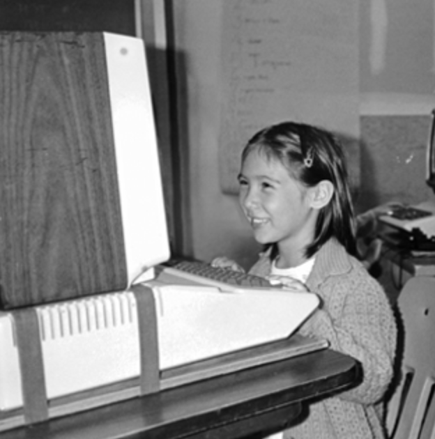 Staff member on computer when she was young