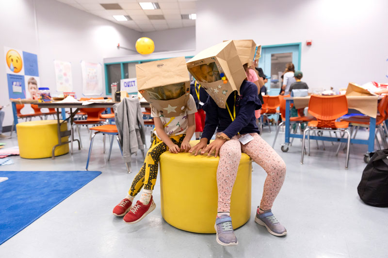 Two students wear the astronaut helmets they have created during Summer Camp