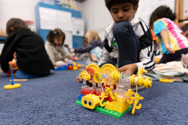 A child displays the toy that he has built during Summer Camp