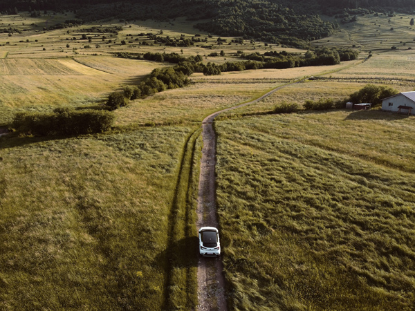 A car traveling on a road in the countryside