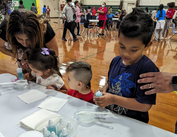 Children and families participate in the Vaccine Learning Hub activities at their school.