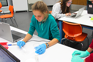 A student is using gene-editing in the Biotech Genetics Teen Research Program.