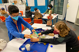 Two students are working on a science activity during the Body Systems and Biomedical Innovations program.