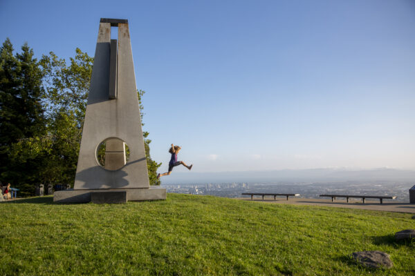 A girl jumps off the Sunstones sculpture in the Forces That Shape the Bay exhibit
