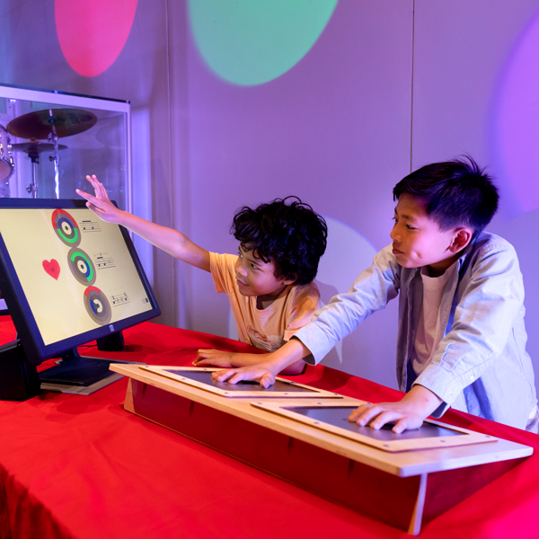 Making Music Exhibit: Two youth are exploring math and music
