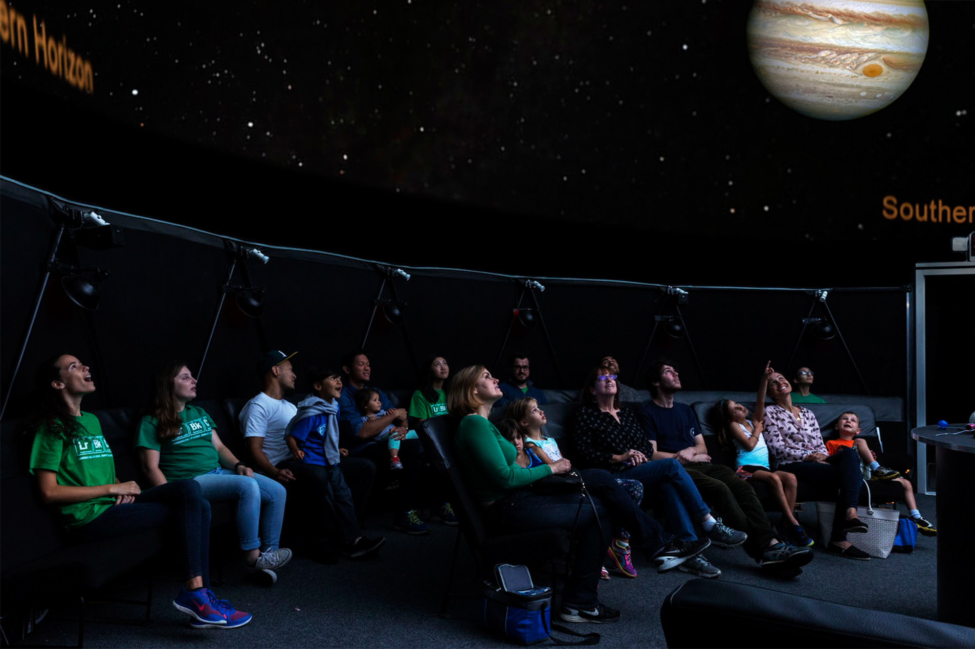 Visitors take in the view of outer space on the Planetarium dome