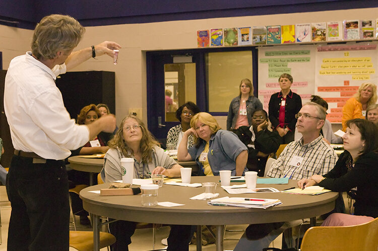 A teacher is presenting to a group of teachers during a professional learning seminar