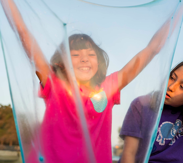 A student holds up her slime during a slime engineering activity