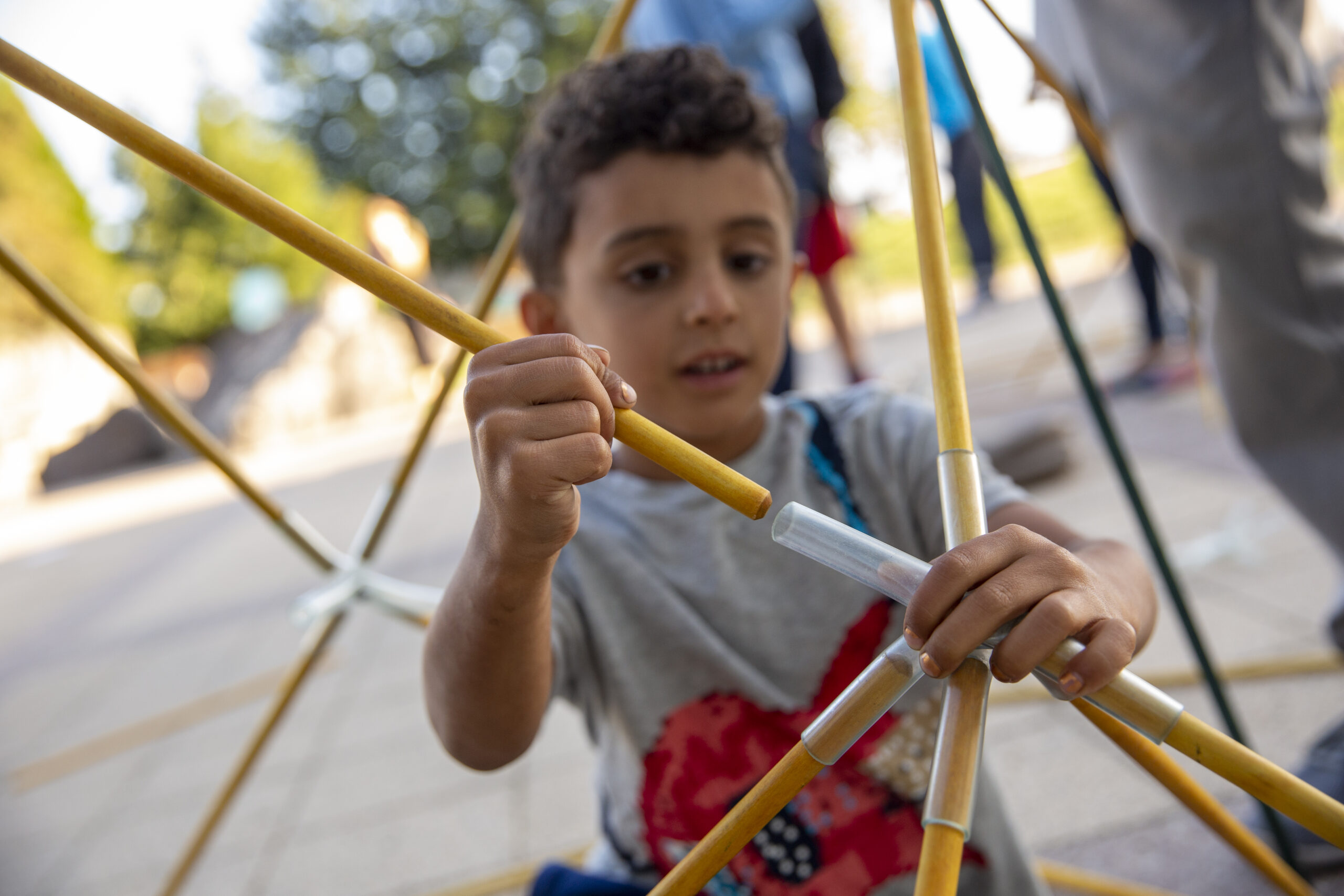 A child interacting with the Giant Geometry activity at The Lawrence.