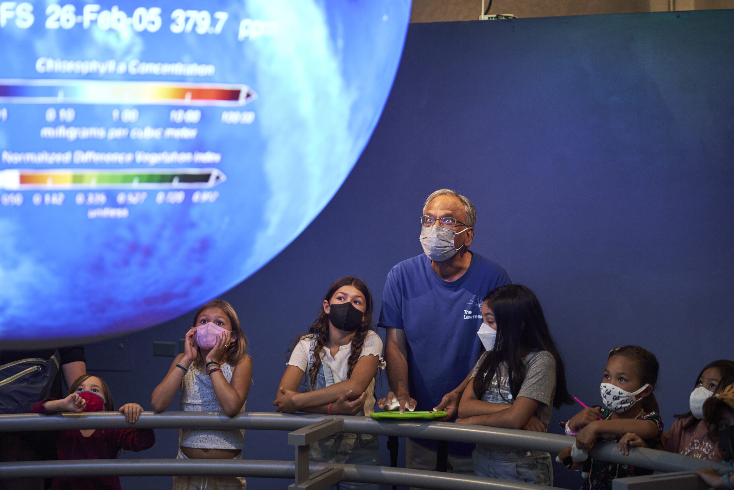 Adult and children observing Science on a Sphere