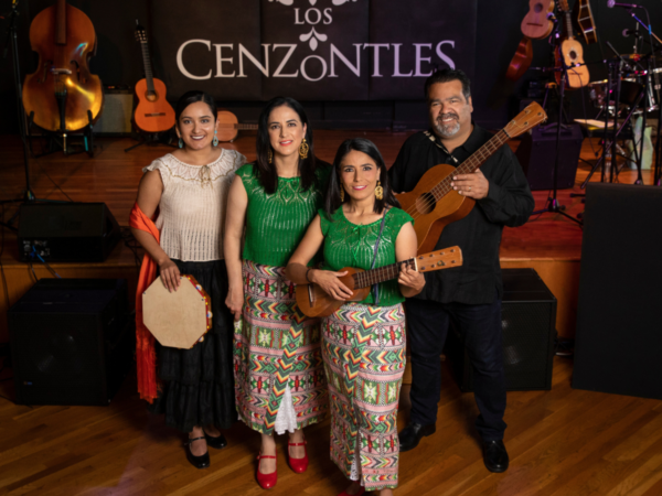 Los Centzontles band posing with the instruments