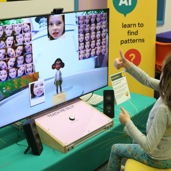 A child explores the Virtually Human AI exhibit.