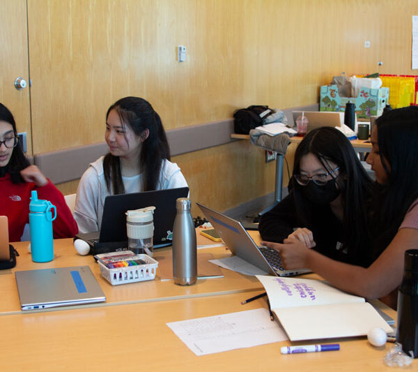 A group of students work together during the Artificial Intelligence teen research program