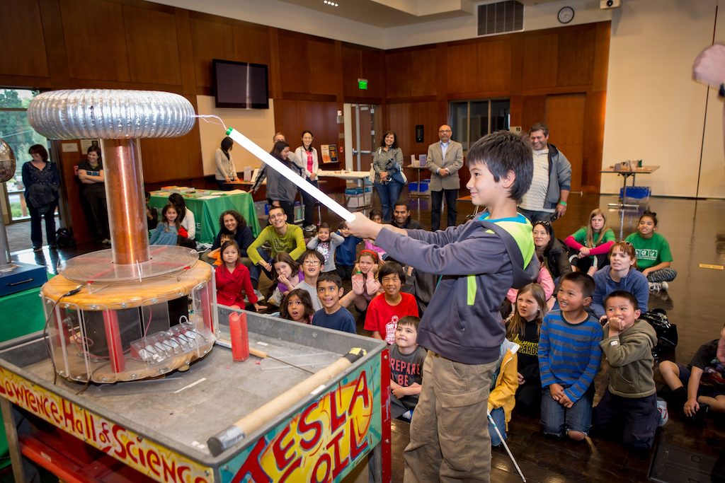 Child participating in electricity demonstration