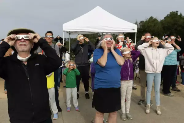 Crowd looking at solar eclipse with eclipse glasses