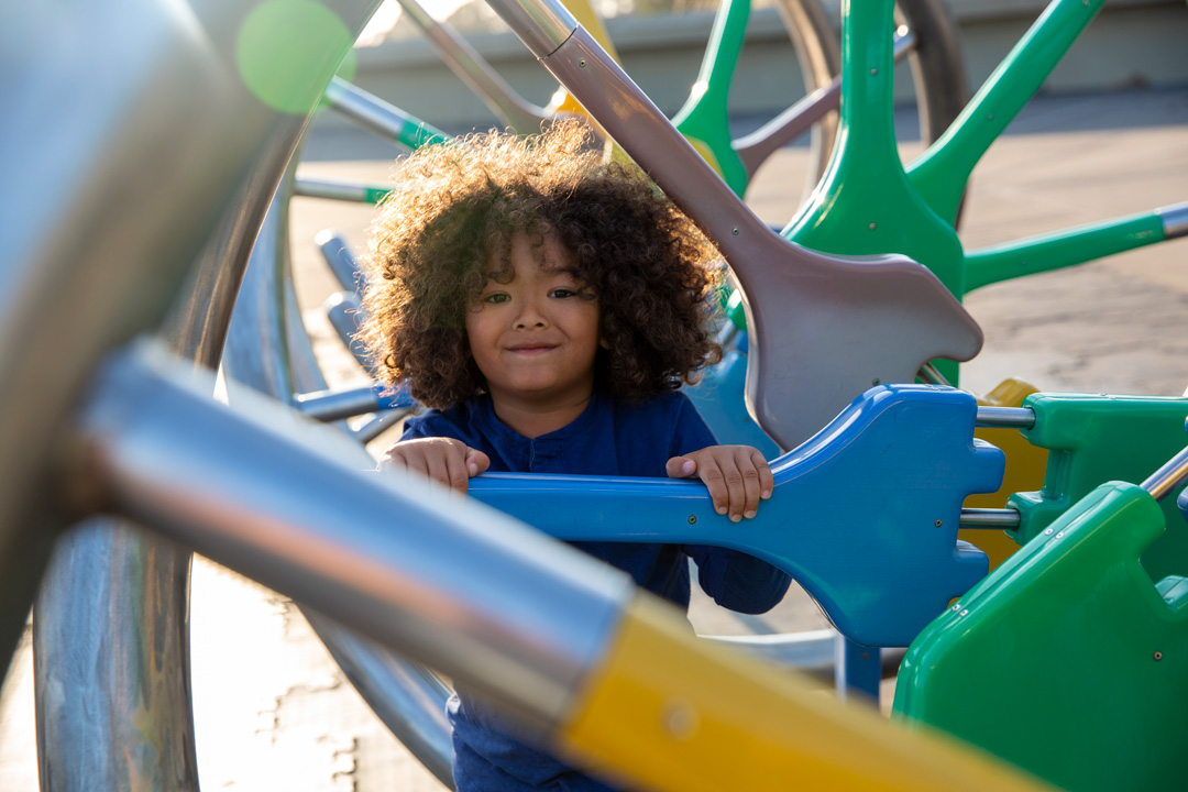 A child climbs on the DNA structure at The Lawrence