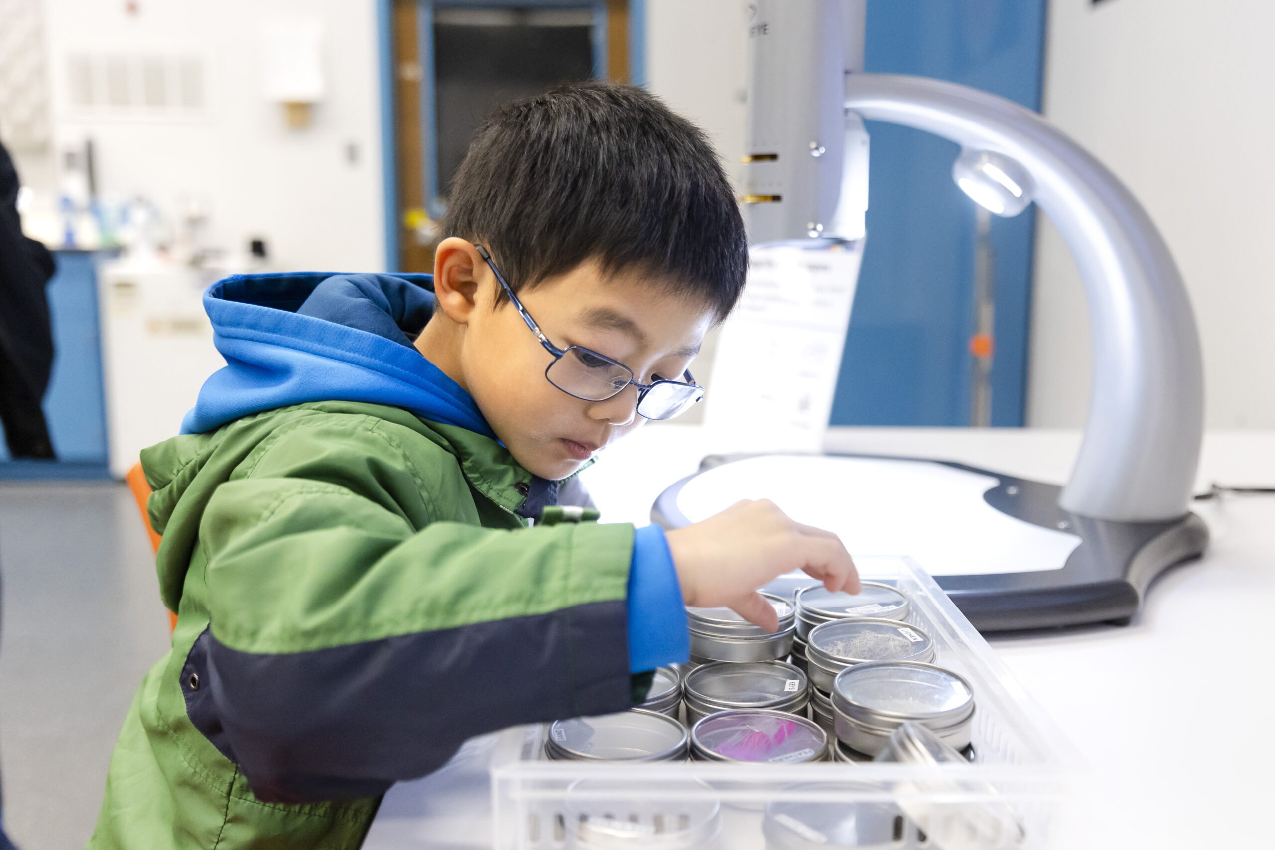 A young child participates in an activity in the Biotech lab.