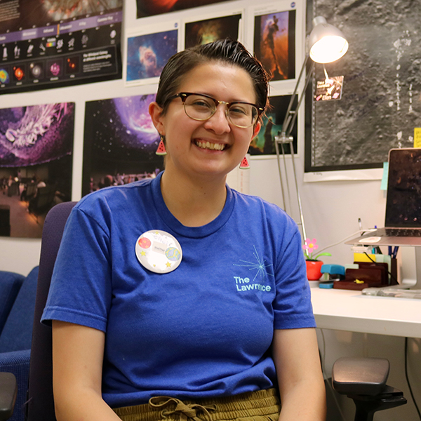 Planetarium Specialist Ellen Thompson sitting at her desk