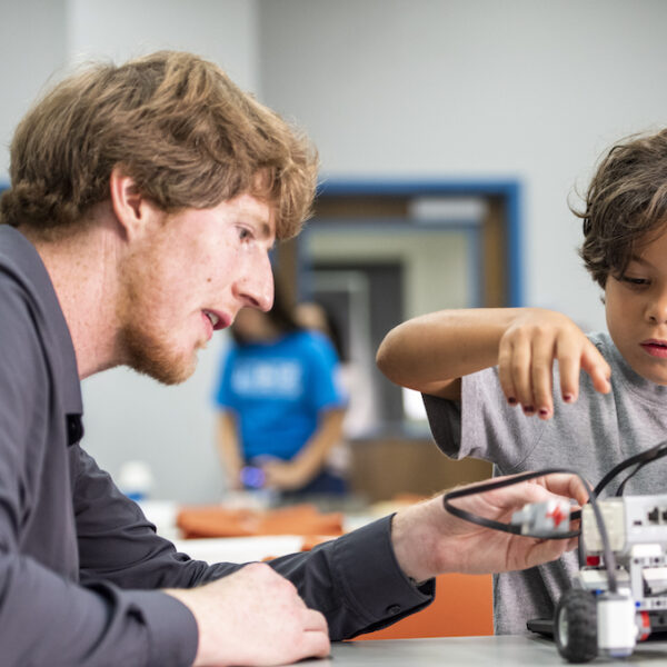 Tim Hurt working on a science project with a kid.