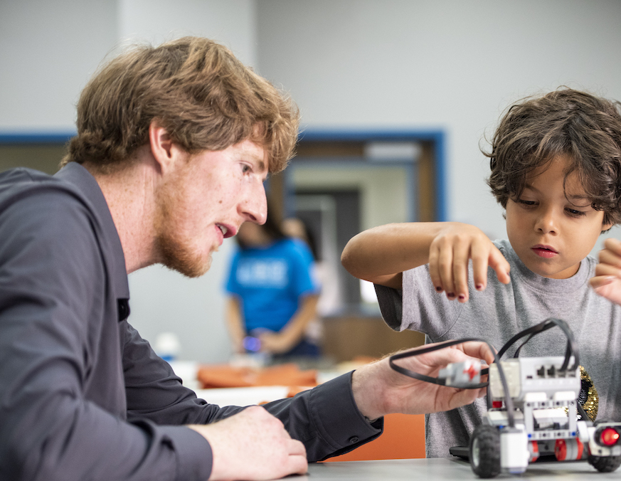 Tim Hurt working on a science project with a kid.