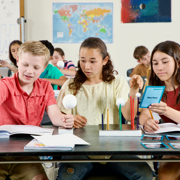 Students in a classroom are working on a SEPUP activity about the moon.