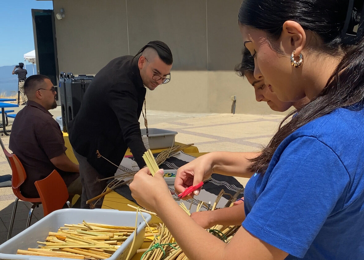 Ohlone Leaders, Vincent and Louis, and staff making tule boats.