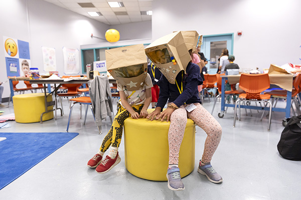Children wearing paper bag masks
