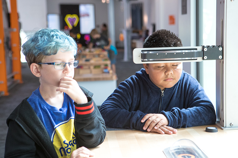Two young visitors interact with the Mindball exhibit