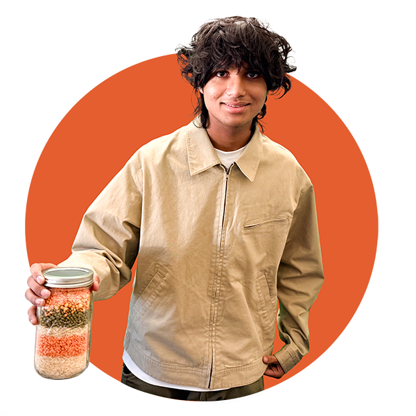 Community Science Hero Aidan Ahmed, holding a jar of grains