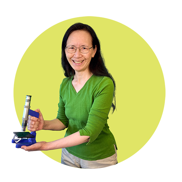 Community Science Hero Annette Chan, holding a microscope