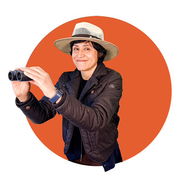 Community Science Hero Blanca Hernandez, holding a pair of binoculars