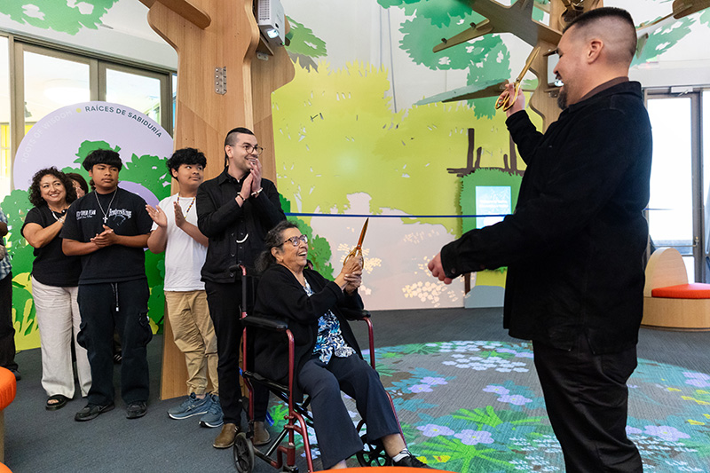 Auntie Dottie, Vincent Medina, Louis Trevino, and other members of the tappenekšekma cut the ribbon to open yuutka